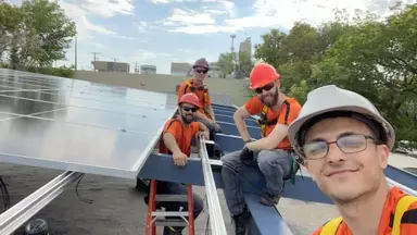 Quality control team inspecting solar panels at Pioneer Solar and Renewables Inc. facility.